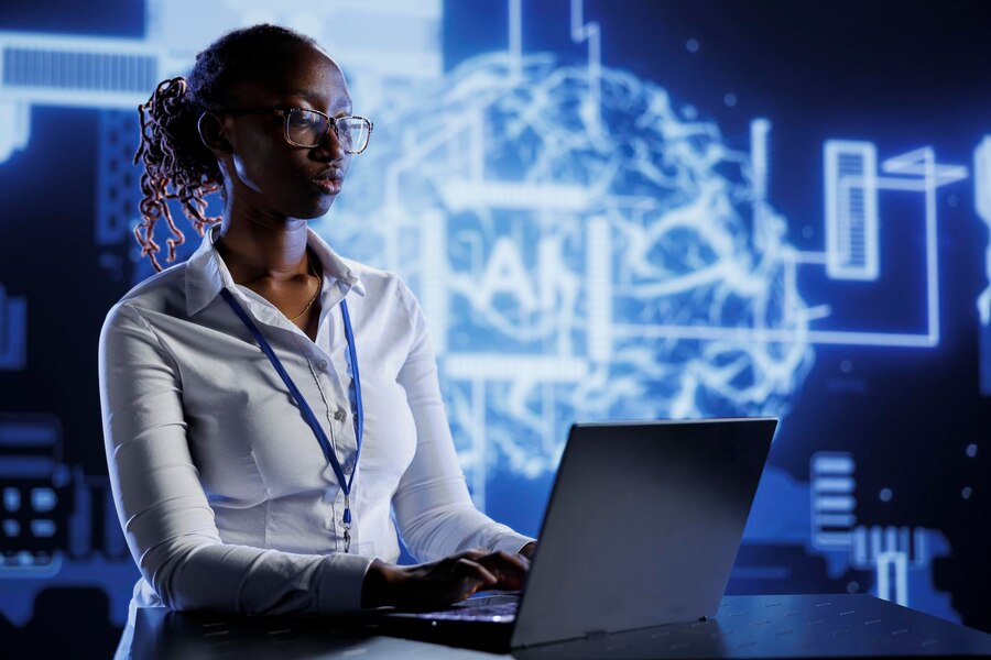 A Black female IT professional wearing glasses,confidently overseeing an AI neural network using a laptop.