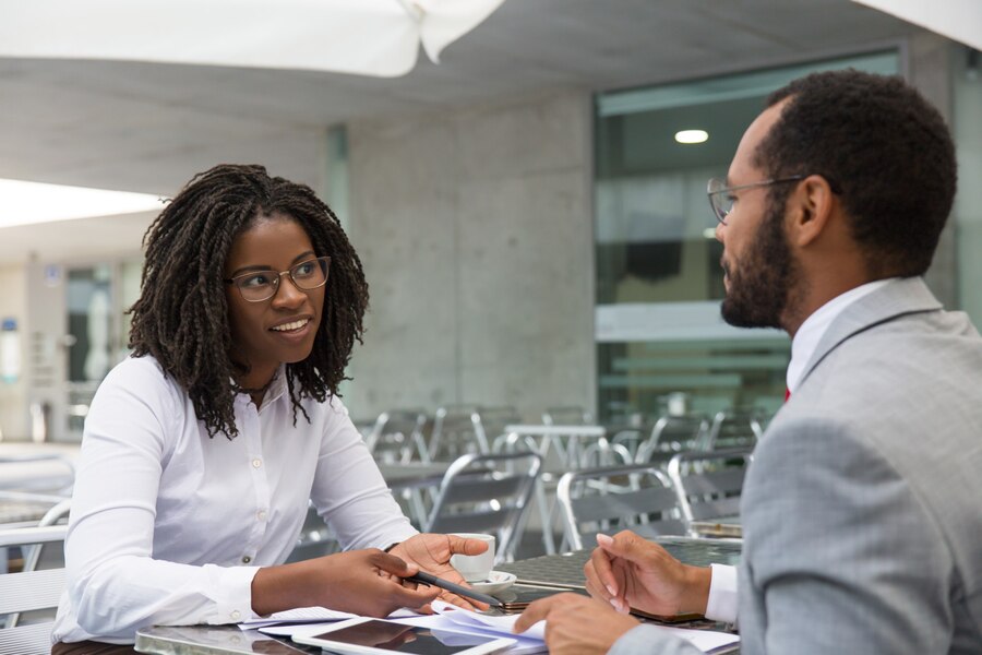 African woman speaking to an african man in a job interview